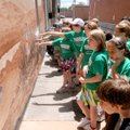 DISPLAYING HISTORY - Central Park Elementary School fourth-graders look for the many early artifacts...