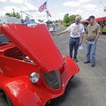 Jim Stokes, left, shows off his 1934 Ford three-window coupe he built to Ed Wieder of Fayetteville o...