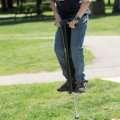 BOUNCING BOY - Eli Barton, 13, of Fayetteville tries out a pogo stick Friday while playing with frie...