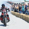 Jeff Schneider, with Ill Conduct Stunt Team of Olathe, Kan., burns his tire Friday as fans watch a s...