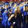 Rogers High School seniors Laddie DeGrand, left, and Taryn Pegram laugh Friday as Pegram loses her m...