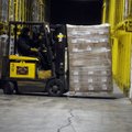 A worker loads a palette of goods into a rack May 13 at the Zero Mountain storage facility in Johnso...