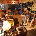 POSTER BOYS - Jason Wilkins, left, and Brett Shook spread blue ink on a screen as Joel Eikenberry fi...