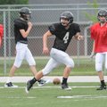 Bentonville’s Dakota Baggett runs through a coverage drill Wednesday during spring practice in Tiger...
