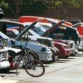 Visitors look over a variety of cars Saturday lined up in the parking lot of the Northwest Arkansas ...