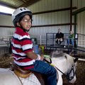 Anthony Ramirez sits on Milo, a horse at Horses for Healing, as he answers question from judges whil...