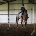 Sean Rice rides Missy through the obstacle course during the Horses for Healing Special Olympics Equ...