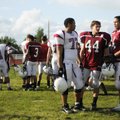 Springdale High football players Pat Morse, from left, Kyle Camp, and Max Montgomery talk on the sid...