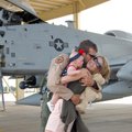 Lt. Wade Hendrickson of Fort Smith hugs his wife, Malea, and his 5-month-old daughter Rylin Saturday...