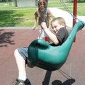Daniel Scott, 8, gets a dizzying spin in a swing powered by his sister Cheyanne Scott, 12, at Gentry...