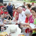 Members of the Student Ministry, left, serve supper Sunday evening during the Fire in the Street blo...