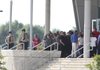 Law enforcement and the public stream into the auditorium Sunday afternoon at West Memphis High School for the visitation for West Memphis police officers Brandon Paudert and Bill Evans, who were shot and killed during a traffic stop along Interstate 40 on Thursday.