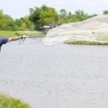 Paul McNeese throws a cast net for shad in Lake Bentonville on Monday in Bentonville. McNeese uses t...