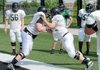 Bentonville offensive linemen Marcus Danenhauer, left, and Emerson DePeel clash Monday in Tiger Stadium in Bentonville.