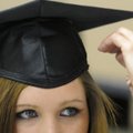 Jessyca Hoskins of Fayetteville gets some help with her cap Monday from GED teacher Debbie Smith. Ho...