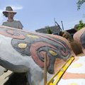 Fayetteville artist Eugene Sargent works Monday on a butterfly-shaped bench at Leverett Elementary S...