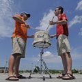 Brad Stowe, left, and Matt Hoffman, both of Fayetteville, play a snare drum Monday in a parking lot ...