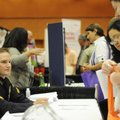 Cpl. Jesse Ray, left, with the Rogers Police Department, speaks with Tony and Lora Marshall during a...