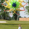 Ian Litchford, 4, runs to fly his kite Monday after his dad, Brian Litchford, not pictured, releases...
