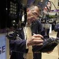 Trader Kenneth Polcari, left, uses a phone post on the floor of the New York Stock Exchange on Tuesd...