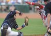 Northwest Arkansas catcher Manny Pina holds onto the ball for an out after colliding with Arkansas baserunner Jeremy Moore in the fourth inning Monday in Arvest Ballpark in Springdale.