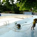 Ryan Layes, assistant pool manager for Fayetteville’s Parks and Recreation Division, uses a pressure...