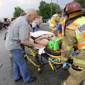 Stephen Varner talks to Sarah Beth Champagne as she is moved to a waiting ambulance Tuesday after be...