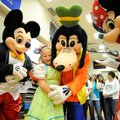 Kassidy Lane, 9, of Siloam Springs is congratulated Tuesday by Disney characters Mickey Mouse, Goofy...