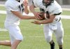 Bentonville running back Alberto Hernandez takes the handoff from quarterback Pearson Gean during spring practice Monday in Tiger Stadium in Bentonville.