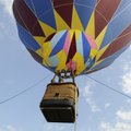 Tanner Anderson, left, and James Higdon get a ride Wednesday in a hot air balloon piloted by Darrel ...