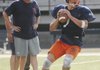 Rogers Heritage’s Jimmy Britton looks to throw the ball during practice Monday in Rogers.