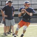 Rogers Heritage’s Jimmy Britton looks to throw the ball during practice Monday in Rogers.