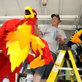 C.J. McPhie of Butte, Mont., stocks his basket game booth with prizes Wednesday while preparing for ...