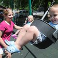  DOUBLE THE FUN - Daniel Sanders, 4, swings Thursday at Dave Peel Park in Bentonville with his mom, ...