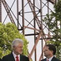 Former President Bill Clinton, left, speaks with U.S. Assistant Secretary of Commerce John Fernandez...