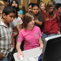  PEEK AT THE FUTURE - Students from Eastside Elementary School in Rogers gather Thursday around Peyt...
