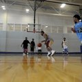  PAYING TO PLAY - Mackson Abta, center, drives toward the basket Thursday during a pick-up game of b...