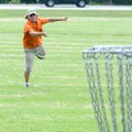  Randal Reisner, designer of the Lake Bella Vista Disc Golf Course, tries a 30-foot putt Friday on H...