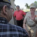 Don Tyson, right, shakes hands Friday with veteran Raymond Jones of Fayetteville at Fayetteville Nat...