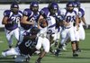  Fayetteville senior Devin Bowers, left, tackles junior Austin Bramwell near the line of scrimmage during the Bulldogs’ annual Purple and White spring game Friday at Harmon Field.
