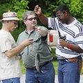 CATCH AND RELEASE - Ron Duncan, middle, holds up a fish caught May 21 by Dekendrick Jett, 14, right,...