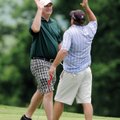 Brett Murphy, left, slaps hands with Adam Russell after Russell sank a par putt on No. 9 during the ...