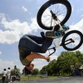  Justin Jester of Centerton performs a “flair” while warming up Saturday before the advanced BMX com...