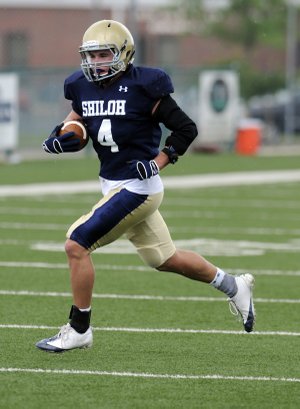 Shiloh Christian’s Garrett Harper carries the ball upfield during Tuesday’s practice in Champions Stadium in Springdale.