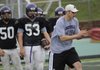 New Fayetteville assistant coach Jeb Huckeba, right, illustrates a certain technique to some of the Bulldogs’ linemen during a May 19 practice at Harmon Field in Fayetteville.
