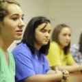  Woodland Junior High School student Andrea Kathol, left, 15, talks Thursday about her thoughts on a...