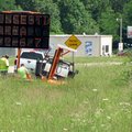 Employees of Direct Traffic Control Inc. of Muskogee, Okla., place a sign on Arkansas 23 just north ...