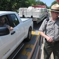 Michael Hurley, right, chief park ranger for Beaver Lake, helps Evan Thiele of Bella Vista purchase ...