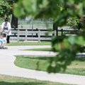 Yolanda Ruiz pushes her son, Daniel Ruiz, 3, around the walking trail at Veterans Park in Rogers on ...