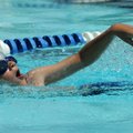 Beck Perry, 7, of Bentonville swims the 100-meter freestyle on Sunday during the Neutrogena Memorial...